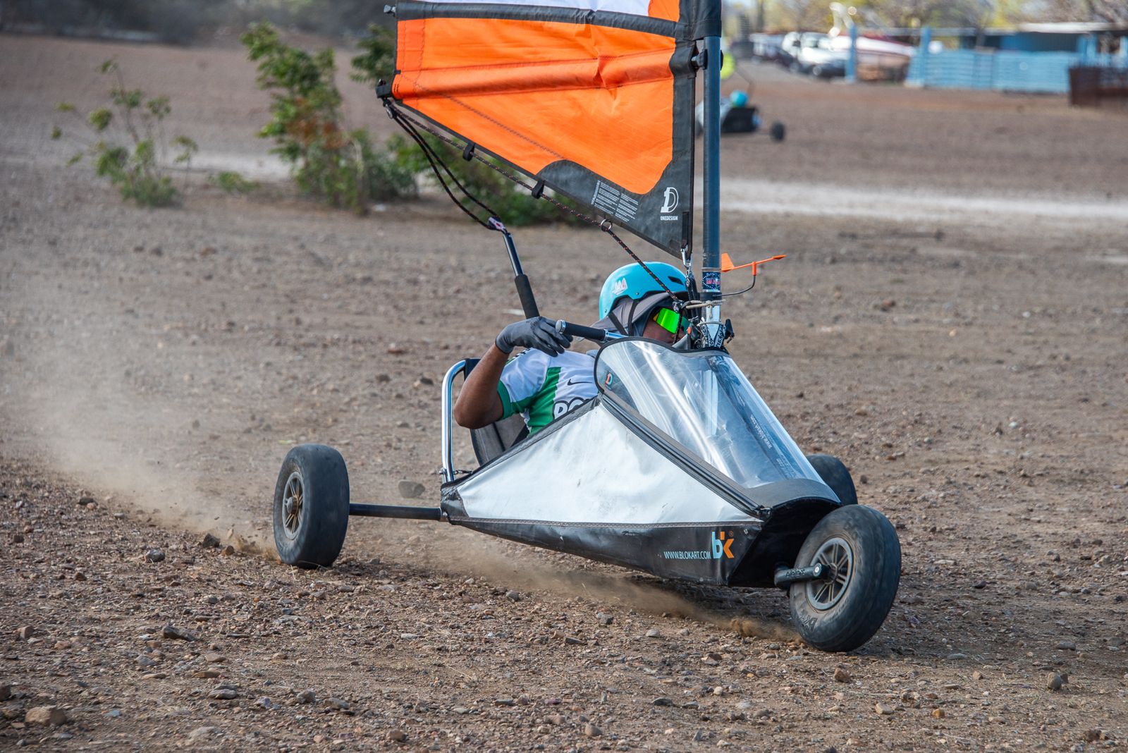 A blokart racing hard, kicking up dust