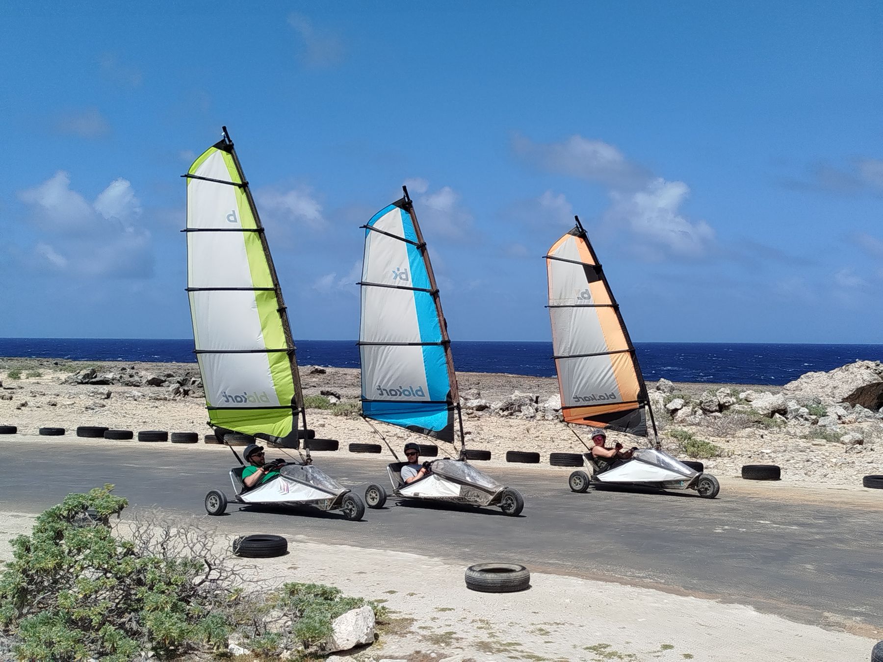 Blokarts racing along the coast road